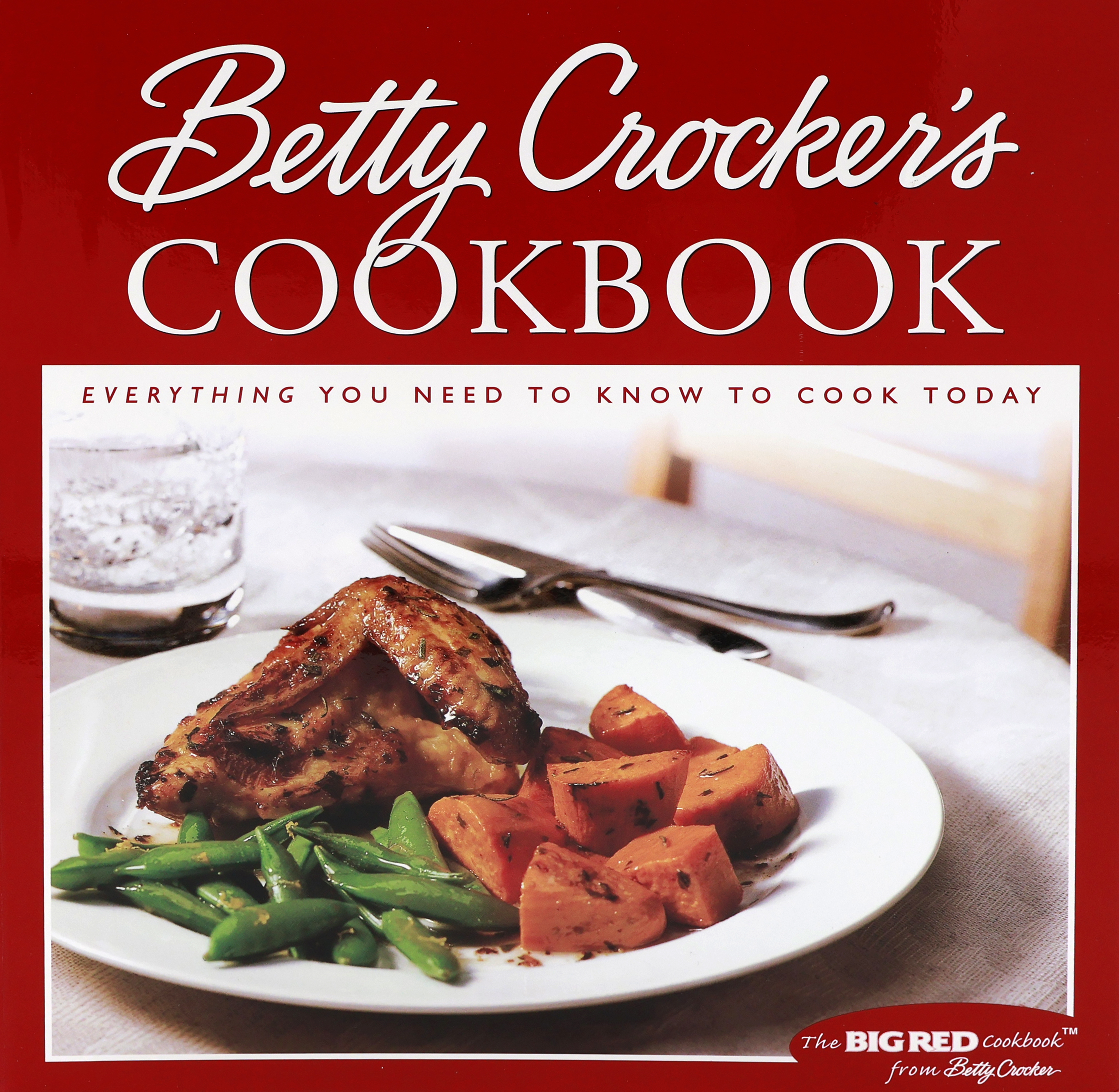 Cover of the 2000 Betty Crocker Cookbook with a red cover that has a large square on the front with the wording “Everything You Need to Know to Cook Today”.  The square has a white plate with a chicken fore section (breast half with wing), green peas in pods and chunks of sweet potatoes.  Says “the BIG RED Cookbook from Betty Crocker” in the lower right corner.